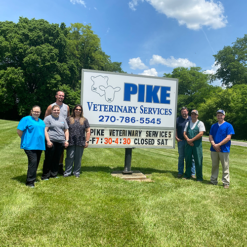 Pike Veterinary team around their business sign